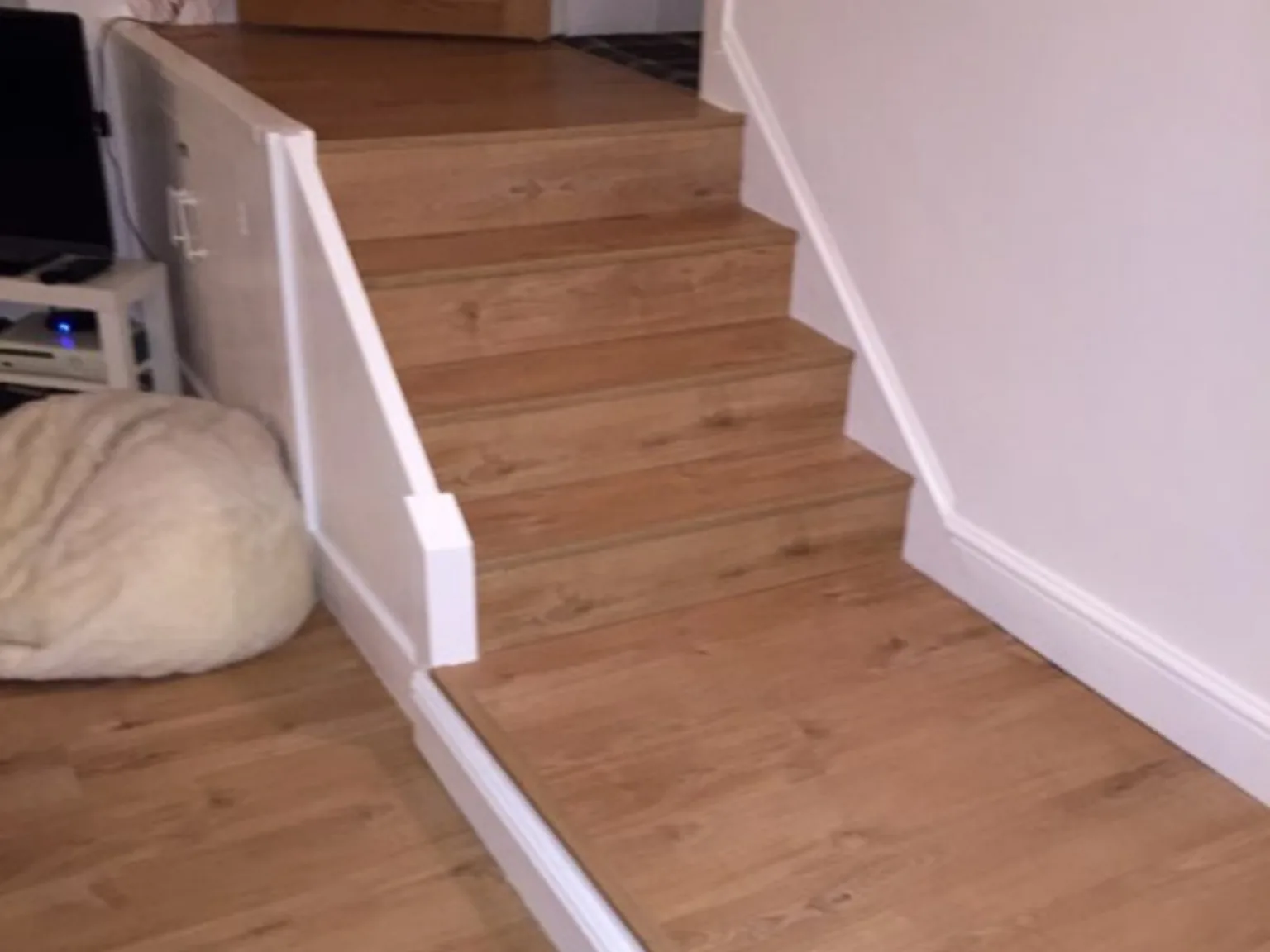 Completed wood-effect staircase and white trim